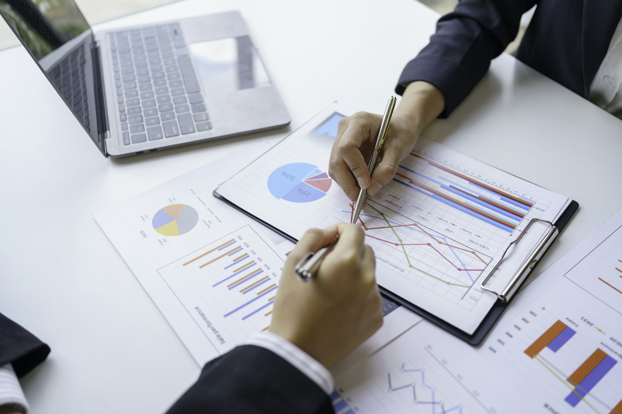 Business people analyzes, graphs and charts to examine and analyze company finances, revenues and bu