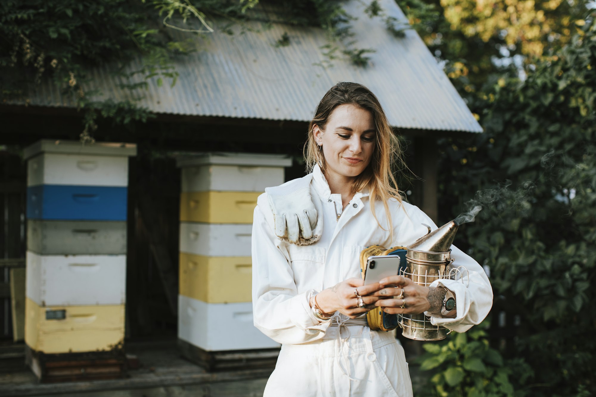 Beekeeper texting on her phone