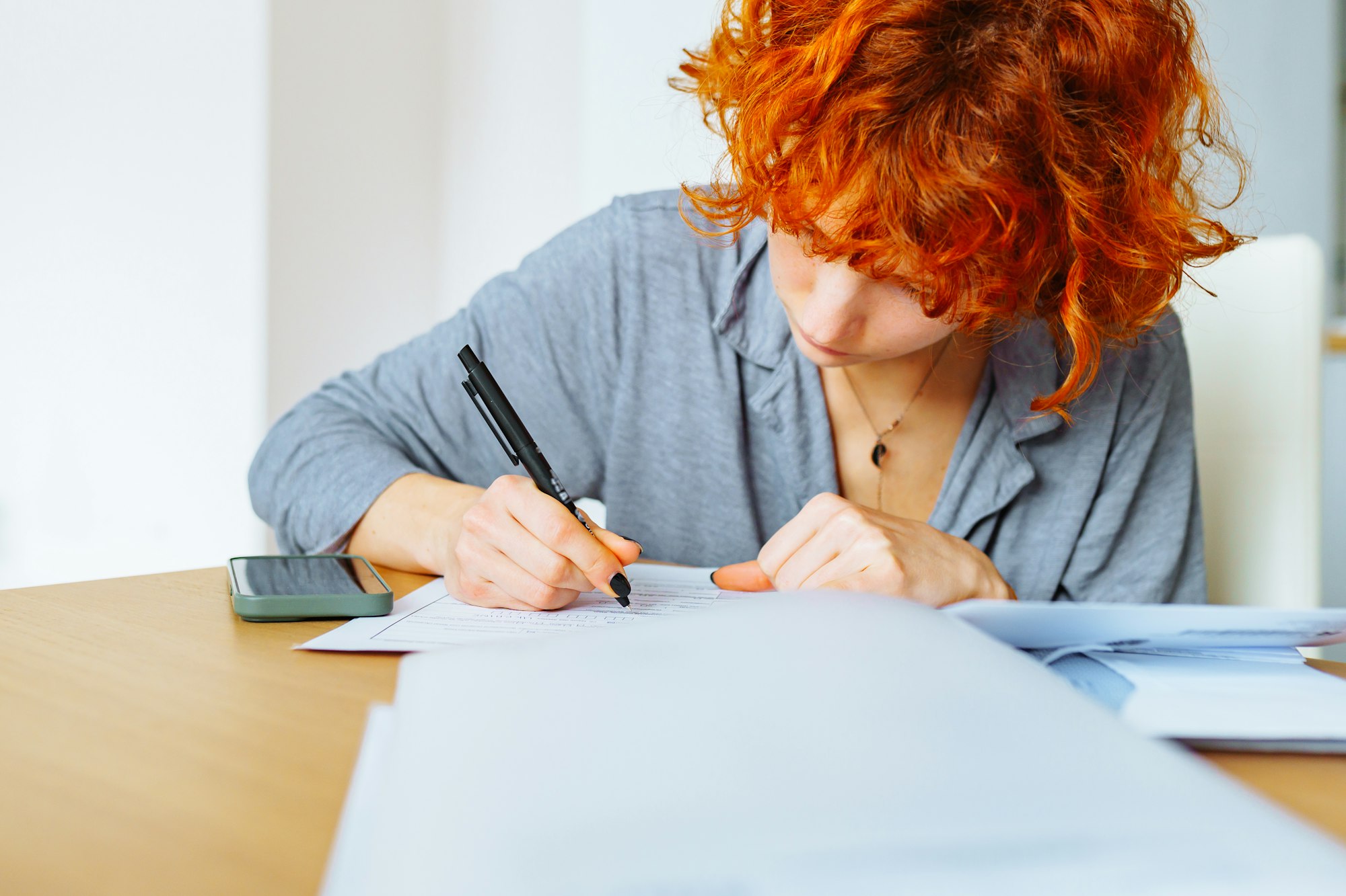 portrait attractive teenage girl filling out paper form